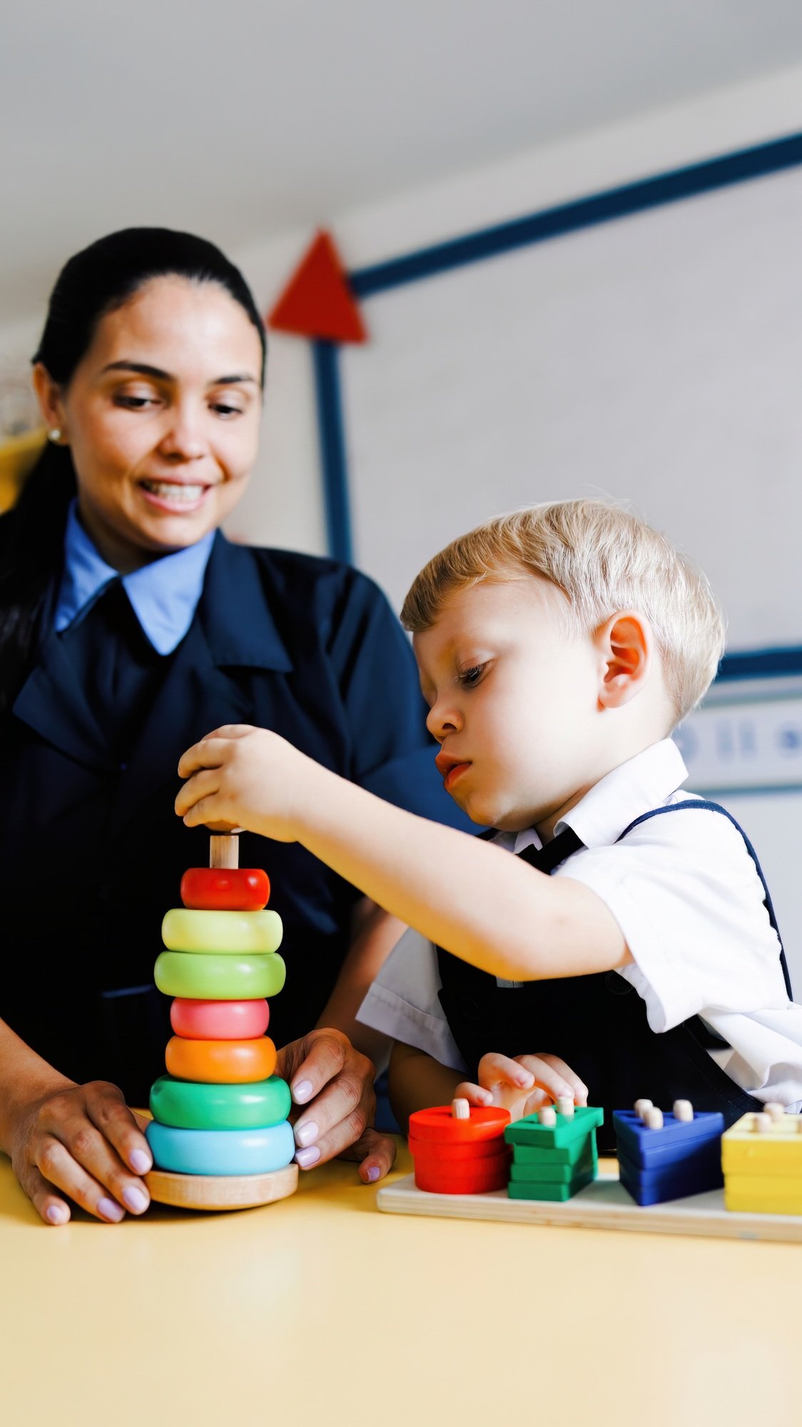 Back to school, Kindergarten teacher and Kid playing with wood toys at preschool room. Education